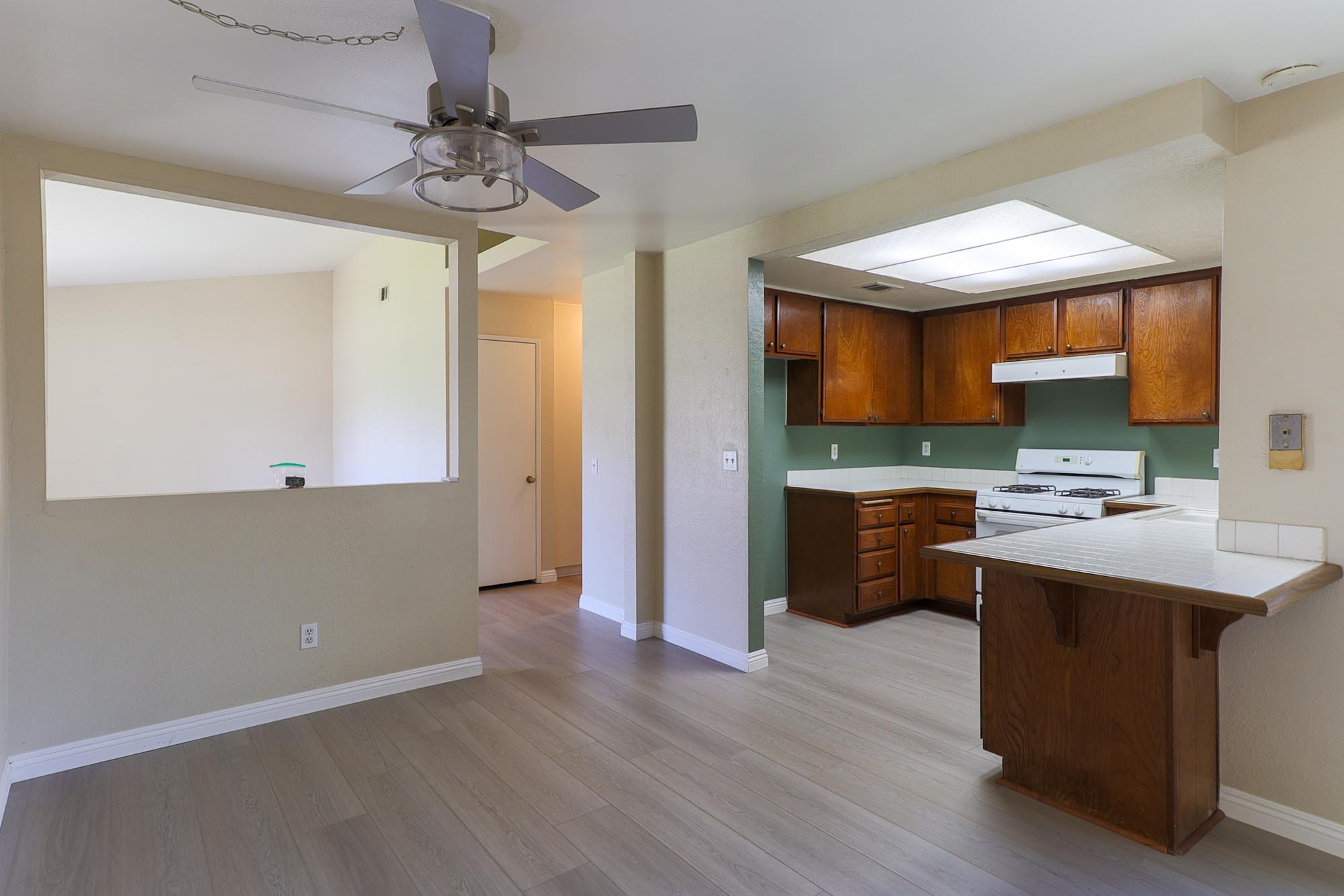 Chardoney looking from the family room fireplace wall to the kitchen and formal living room photo