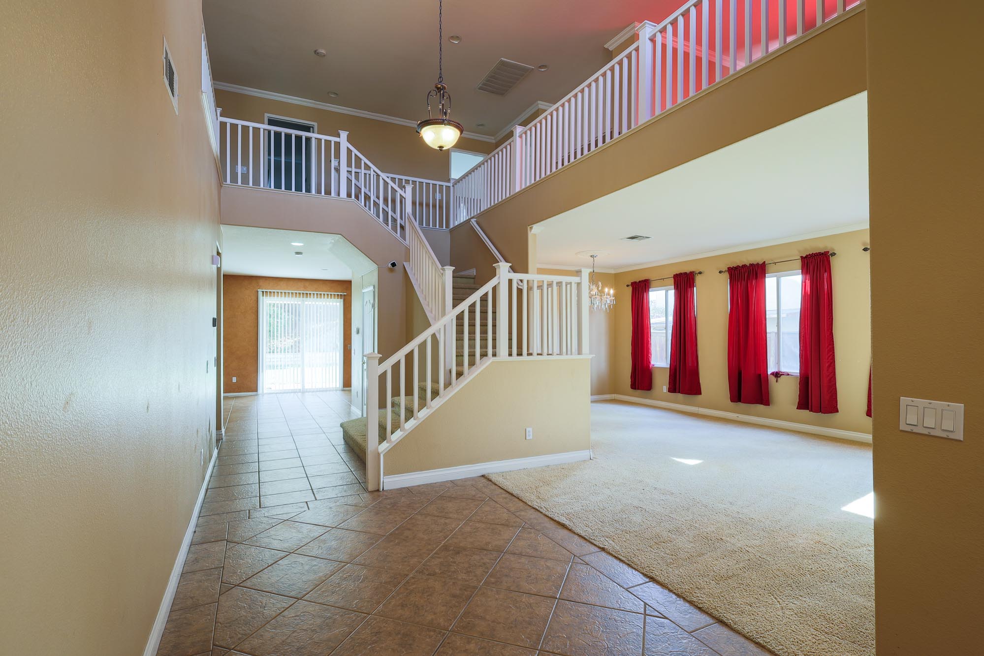 Letterman standing at front door looking at stairs and formal living areas photo