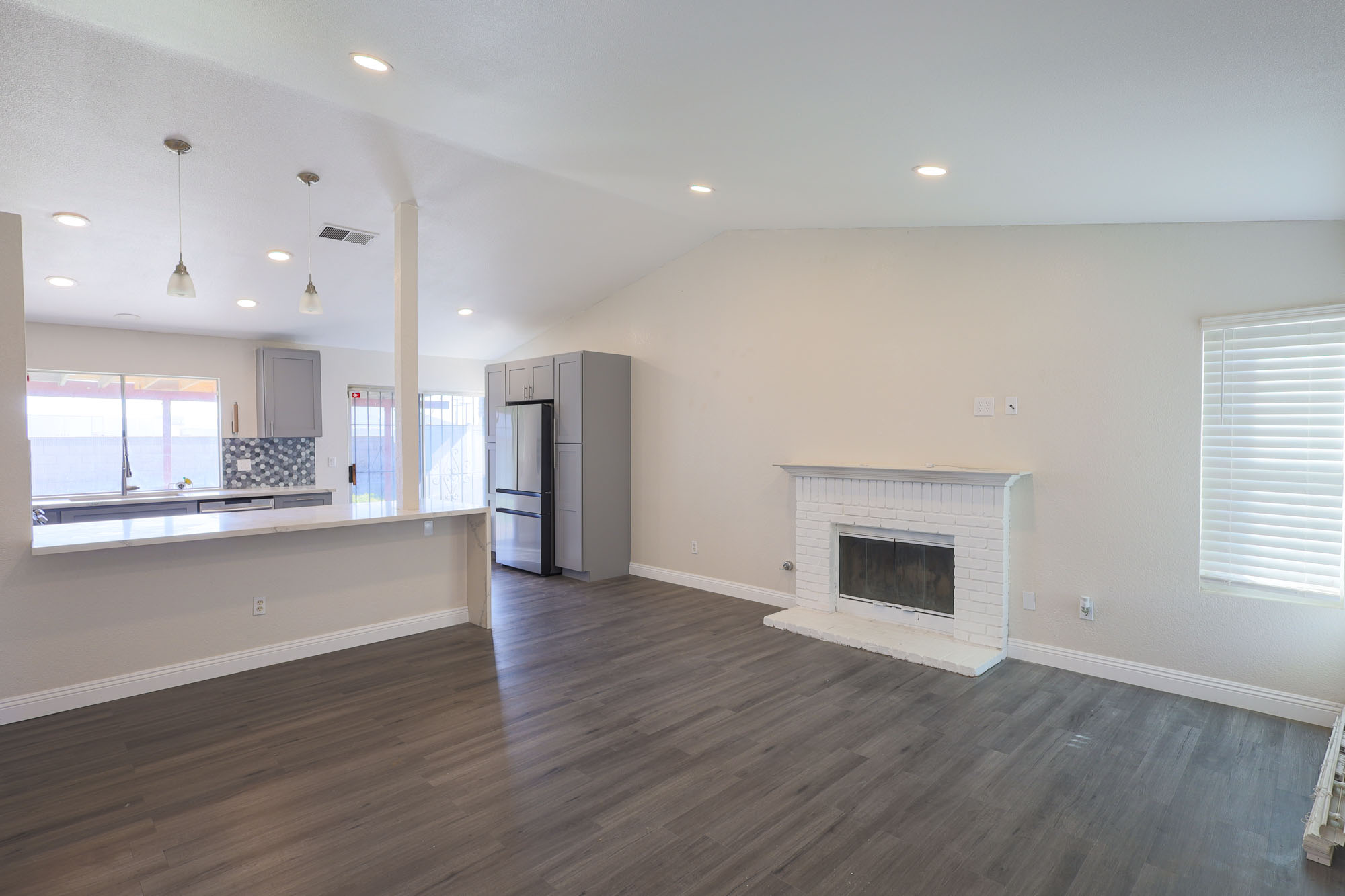 Acapulco family room with fireplace looking toward kitchen photo